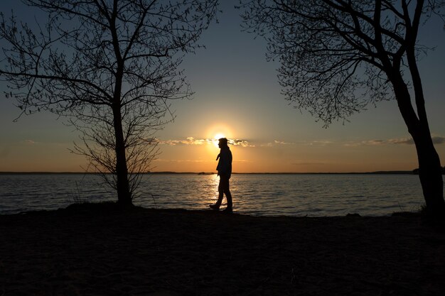 Sad and contemplative person near lake