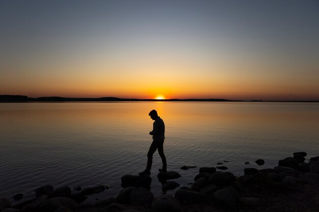 Sad and contemplative person near lake