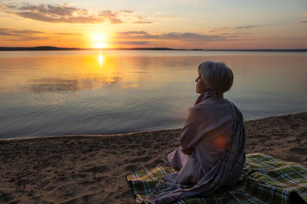 Sad and contemplative person near lake