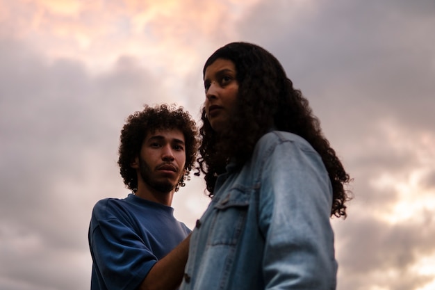 Free photo sad couple sitting together outdoors