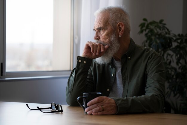 Sad elder man at home