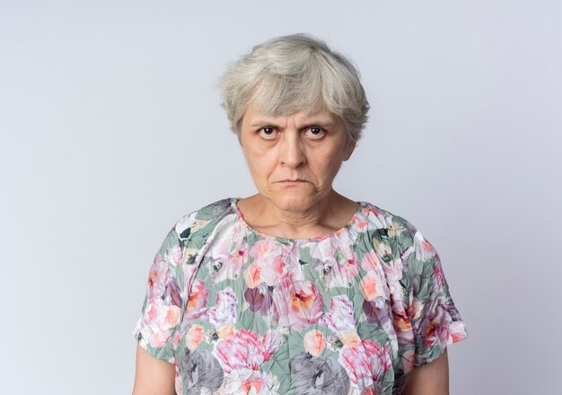 Sad elderly woman looking isolated on white wall