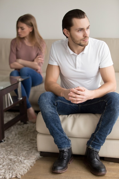 Sad frustrated couple after fight, serious man thinking of breakup