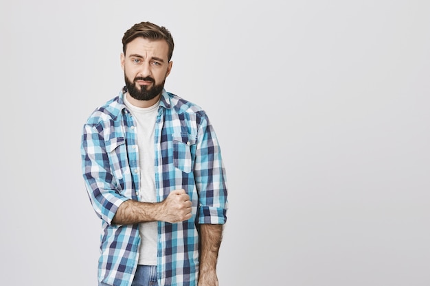 Sad guy trying cheer-up, fist up boosting confidence