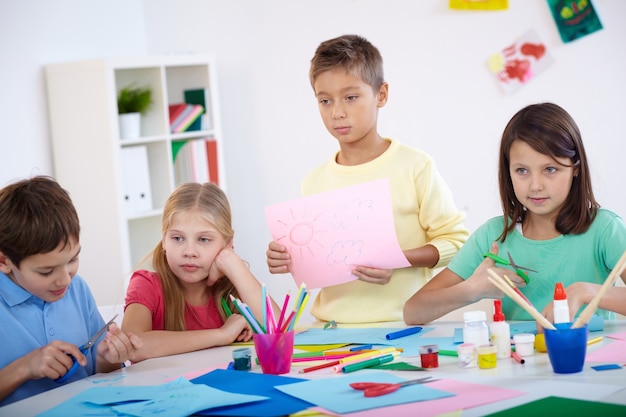 Sad little boy with his drawing