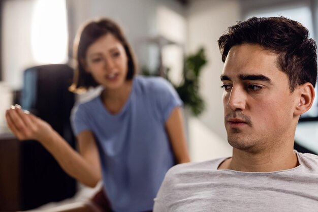 Sad man having a conflict with his girlfriend and thinking of their relationship difficulties