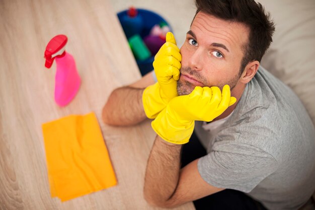 Sad man with cleaning equipment