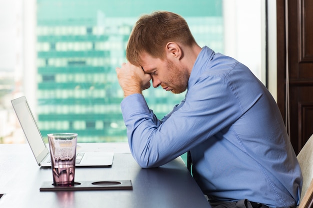 Free photo sad man with fist on forehead