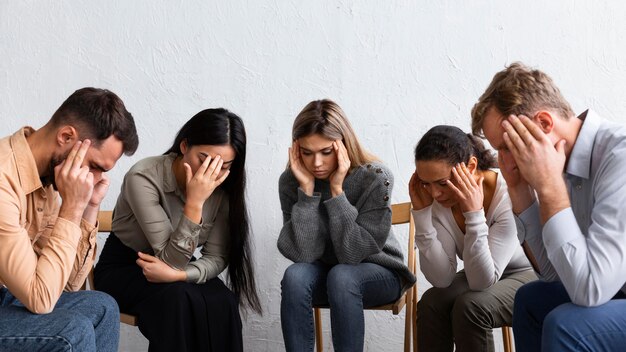 Sad people at a group therapy session