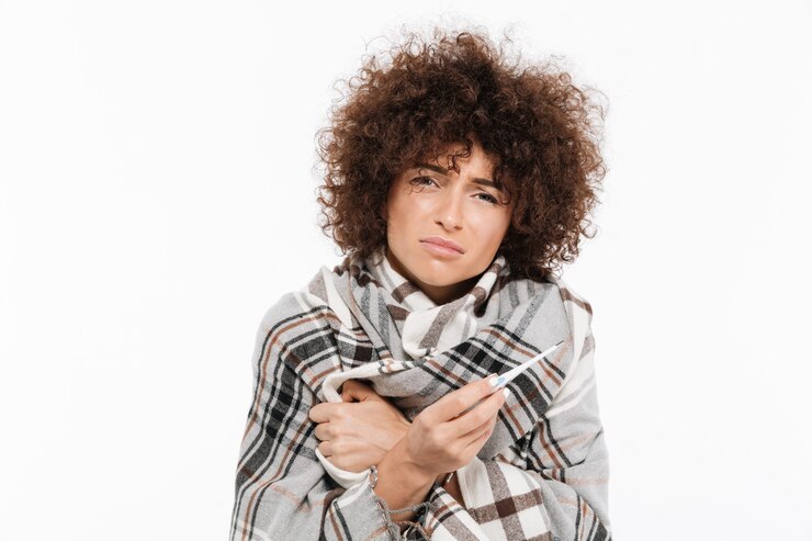 Free Photo sad sick woman standing wrapped in a blanket