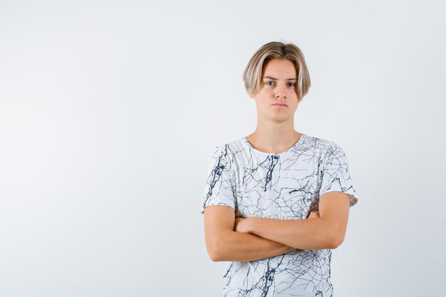 The sad teenager boy is thinking on white background