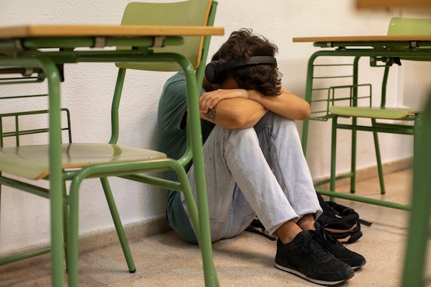 Free photo sad teenager at school full shot