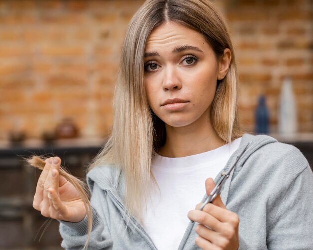 Sad woman after cutting her own hair