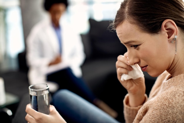 Sad woman crying while having therapeutic session with mental health professional