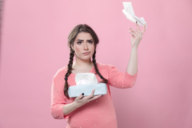 Sad woman throwing napkins in the air