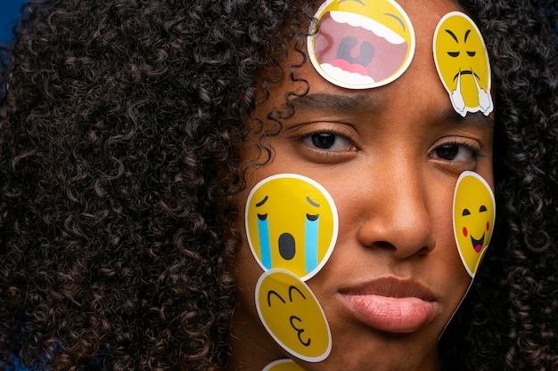 Sad woman with emojis on face