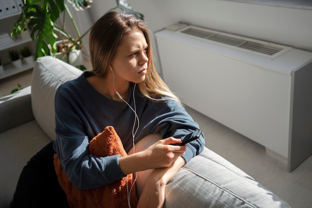 Free photo sad young woman at home