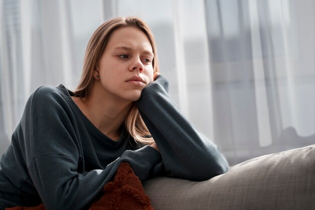 Sad young woman at home