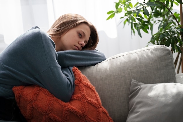 Free photo sad young woman at home