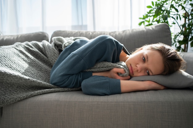 Free photo sad young woman at home