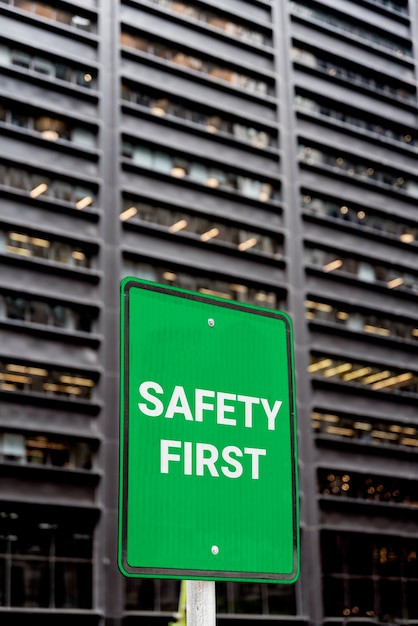 Free photo safety first sign  in front of building