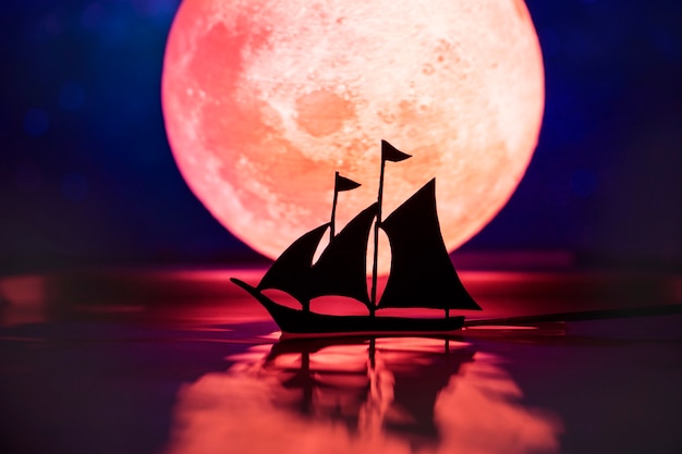 Free photo sailing ship with full moon in the night