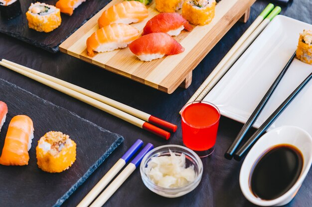 Sake and condiments near rolls