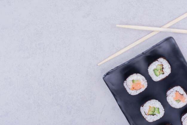 Sake maki rolls in a ceramic black platter 