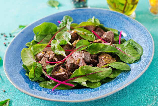 Free photo salad of chicken liver and leaves of spinach and chard.