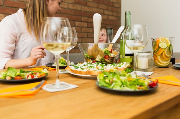 Salad dishes on table and family