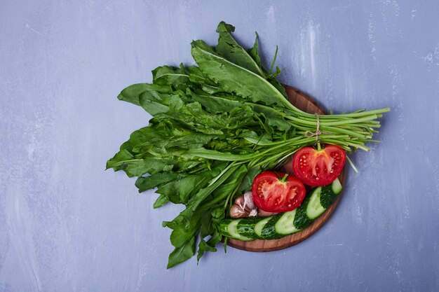 Salad and herbs on blue