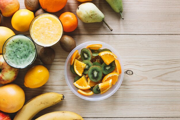 Salad near fruits and smoothies