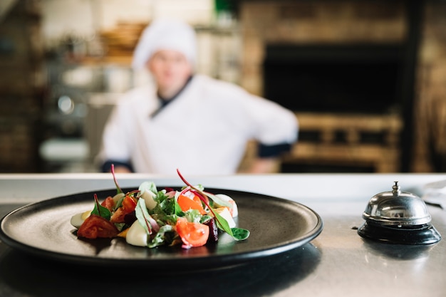 Salad on plate with service bell