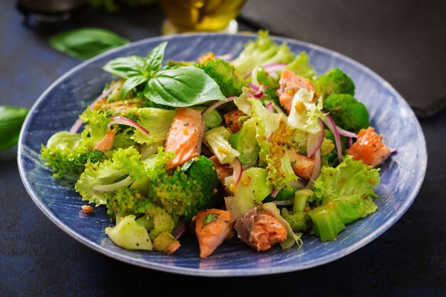 Salad of stewed fish salmon, broccoli, lettuce and dressing. Fish menu. Dietary menu. Seafood - salmon.