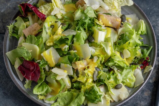 Salad with chicken chunks served on plate. Closeup