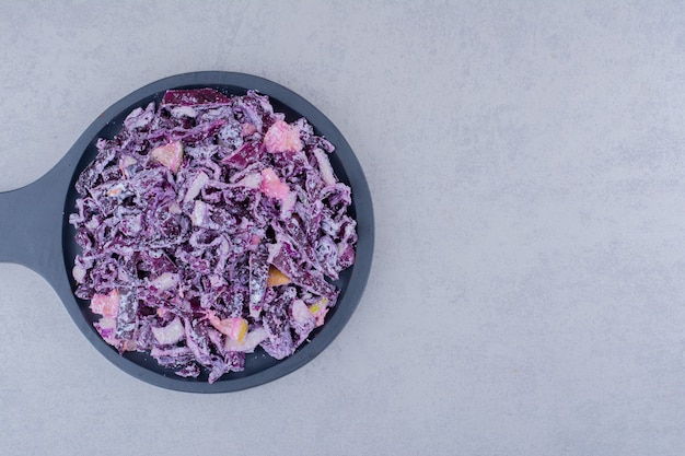 Salad with chopped and minced purple onion and cabbage