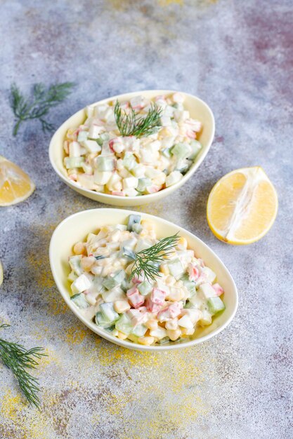 Salad with crab sticks, eggs, corn and cucumber.