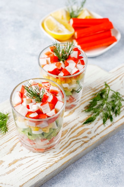 Salad with crab sticks, eggs, corn and cucumber.