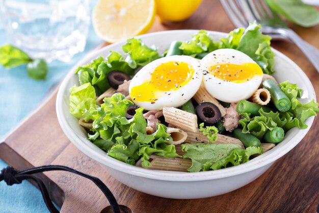 Salad with greens pasta tuna and egg