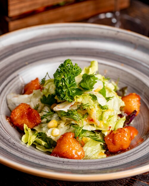 Salad with lettuce chicken corn and greens