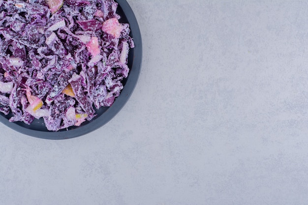 Salad with purple cabbage and onion in a plate