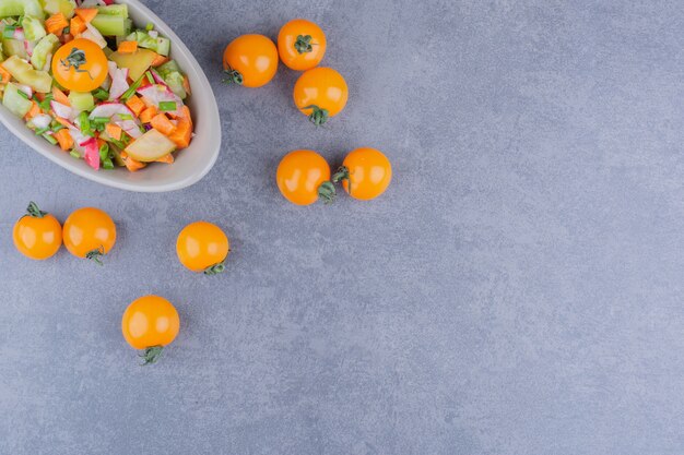 Salad with seasonal herbs and vegetables in a bowl