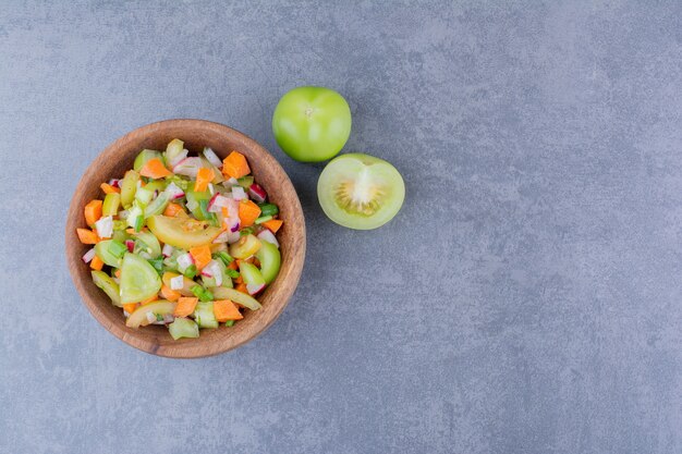 Salad with seasonal herbs and vegetables in a bowl