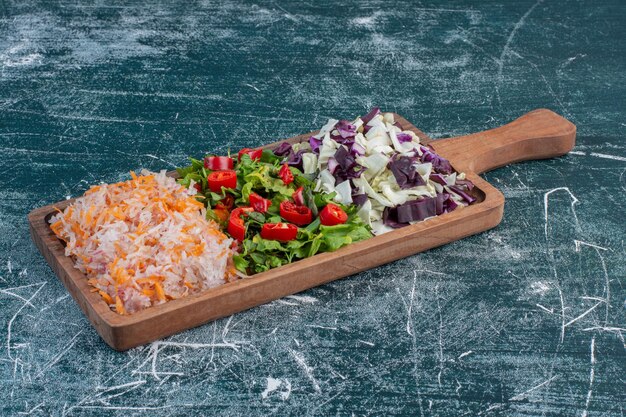 Salad with variety of ingredients including cherry tomatoes, herbs and spices. 