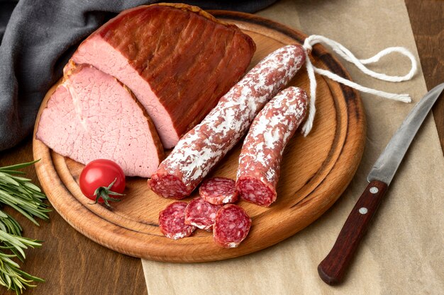 Salami and fillet meat on wooden board