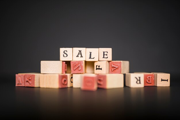 Sale inscription on wooden blocks on table