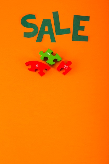 Sale lettering of paper on orange background