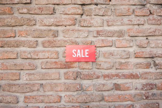 Sale tablet on brick wall