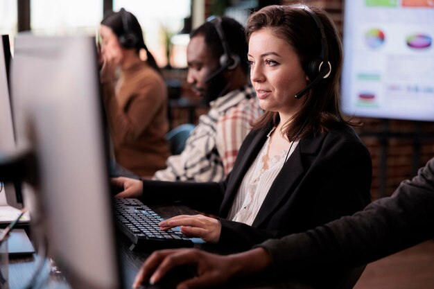 Sales assistant being employed at customer care support job, working on telemarketing call center at helpdesk. Female receptionist with helpline service helping clients on remote communication.