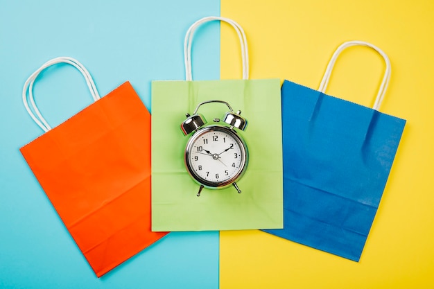 Free photo sales concept with alarm on colorful bags